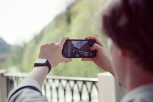 a person taking a picture with a cell phone